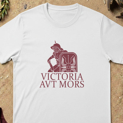 White gladiatort-shirt with red graphic and text on a sandy background
