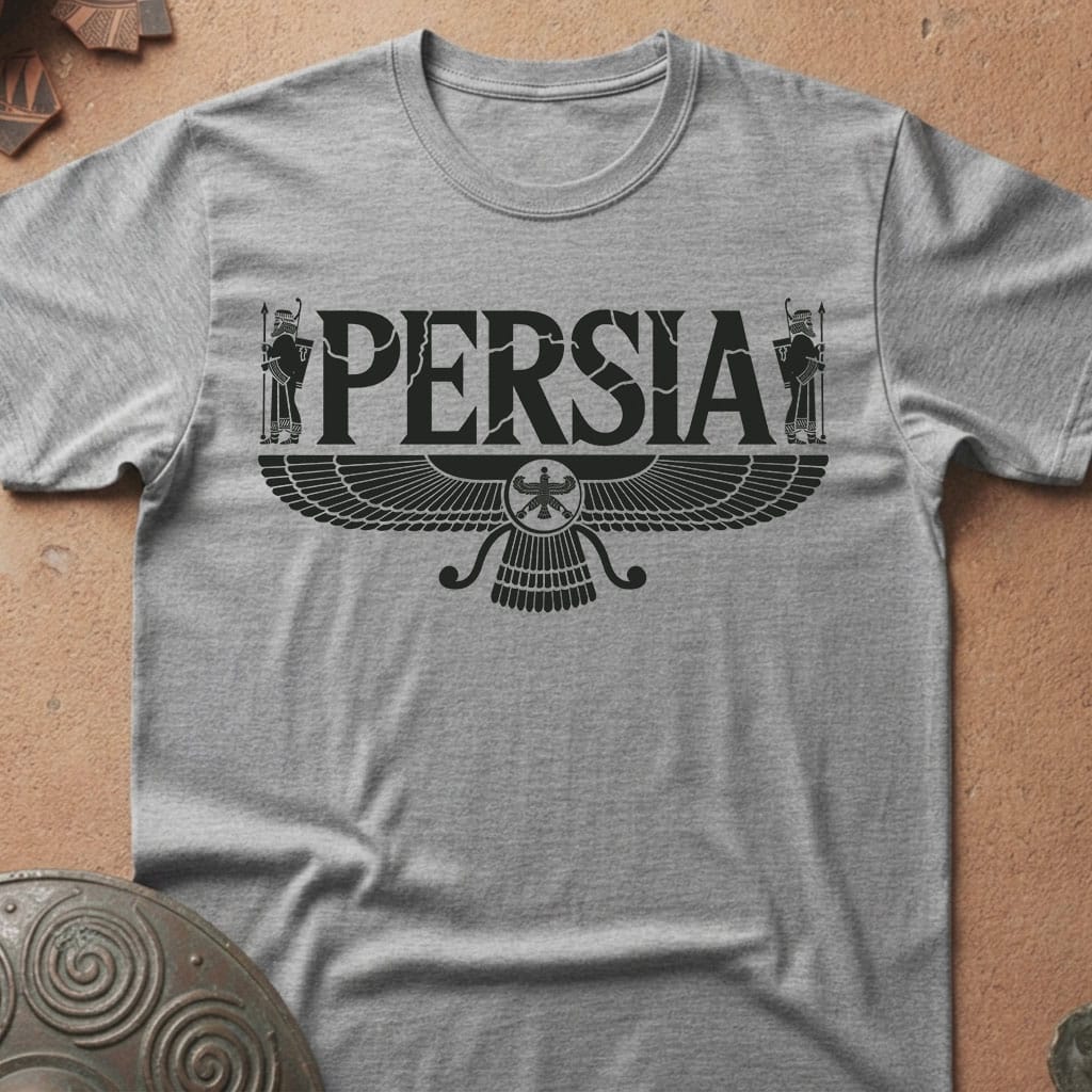 A heather gray crewneck t-shirt featuring a black graphic print of the word 'PERSIA' above a stylized winged emblem, laid flat on a textured tan surface.