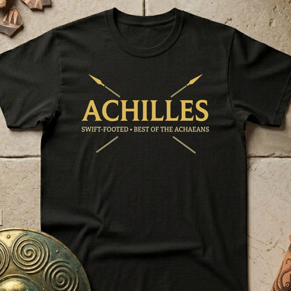 A black short-sleeve crewneck t-shirt with a gold graphic print on the chest reading 'ACHILLES' and 'SWIFT-FOOTED • BEST OF THE ACHAEBANS' with crossed spears, displayed flat on a textured stone background.