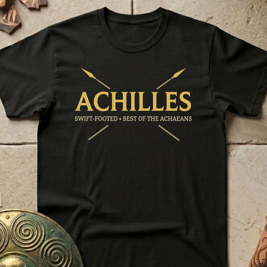 A black short-sleeve crewneck t-shirt with a gold graphic print on the chest reading 'ACHILLES' and 'SWIFT-FOOTED • BEST OF THE ACHAEBANS' with crossed spears, displayed flat on a textured stone background.