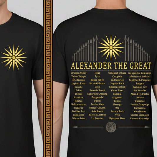 A black short-sleeve graphic T-shirt shown on a torso mannequin against a light gray studio background. The shirt features a large gold starburst on the chest, a vertical gold spearhead motif, and a large gold text block reading 'ALEXANDER THE GREAT' above a list of names and campaign names.