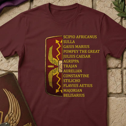 Maroon t-shirt with gold Roman generals design and text on a stone surface