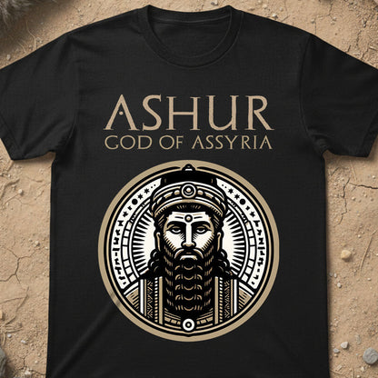 Black t-shirt with 'Ashur, God of Assyria' design on a textured beige background