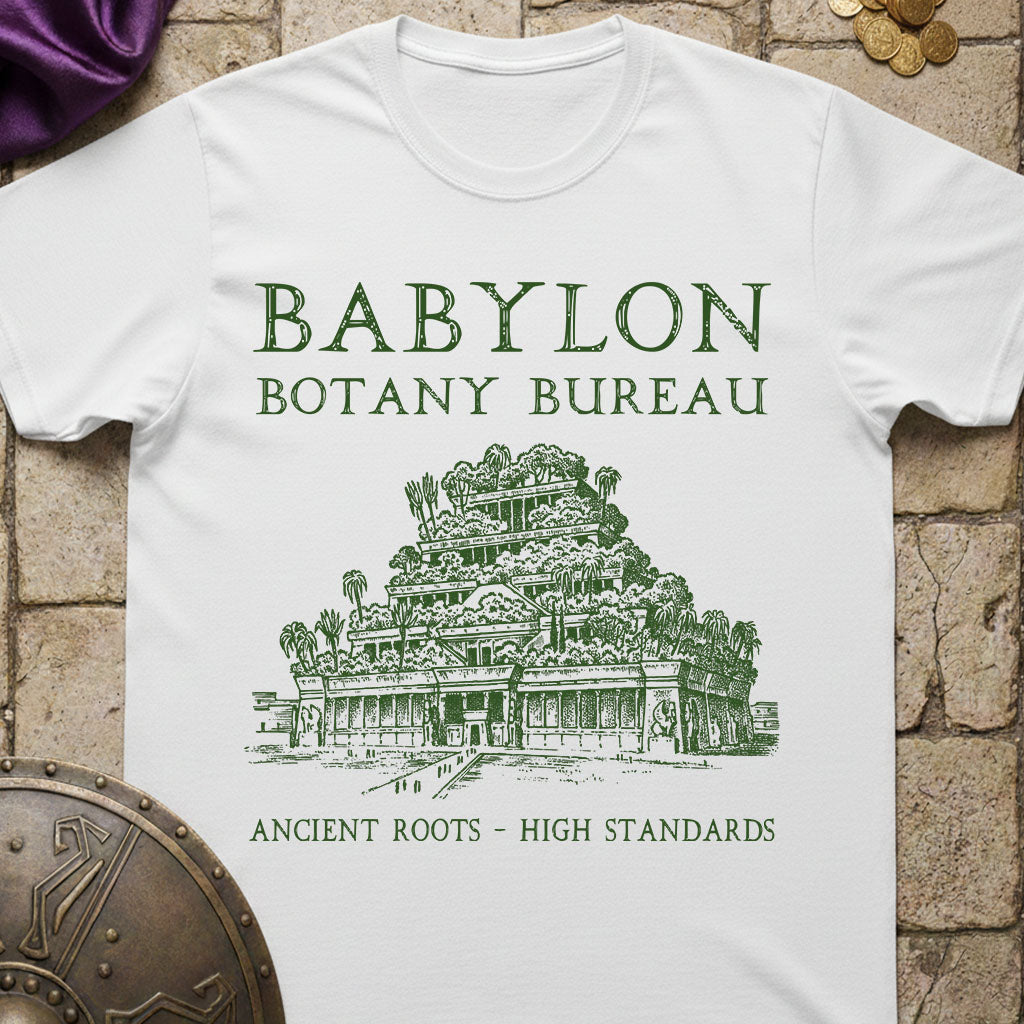 White t-shirt with 'Babylon Botany Bureau' design on a stone surface