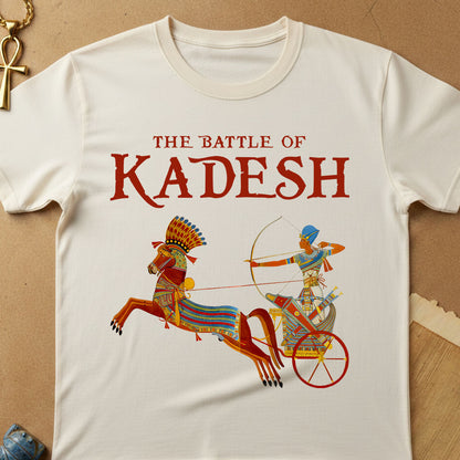 White t-shirt with 'The Battle of Kadesh' design featuring a chariot and warrior on a beige background.