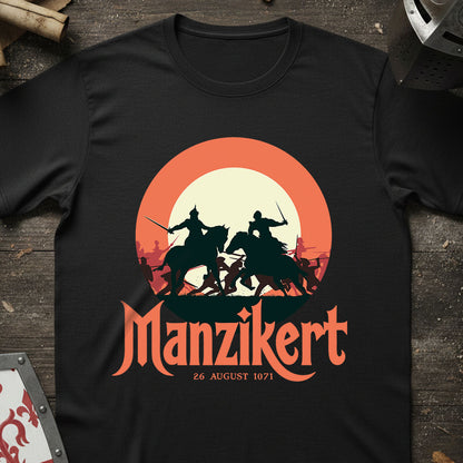 Black t-shirt with 'Manzikert' graphic design featuring warriors on horses against a sunset background.