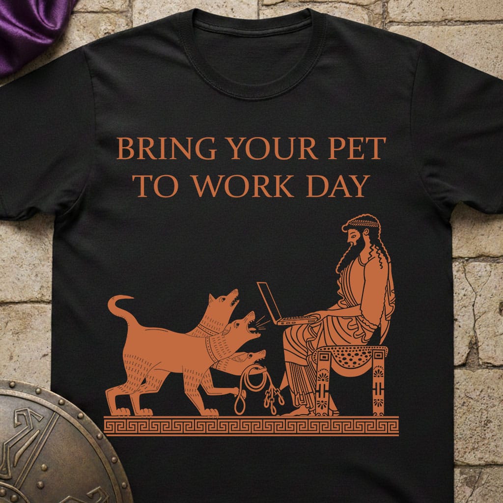 Black t-shirt with orange graphic and text 'BRING YOUR PET TO WORK DAY' on a stone surface.