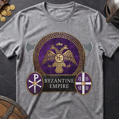 Gray t-shirt with Byzantine Empire design on a dark surface with coins and a helmet.
