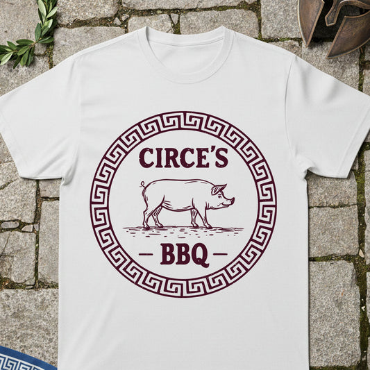 White t-shirt with 'Circe's BBQ' graphic on a stone surface