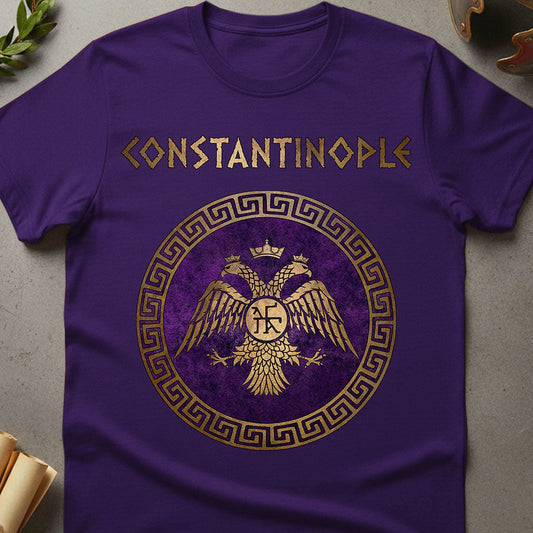 Purple t-shirt with gold 'Constantinople' and eagle design on a gray surface.