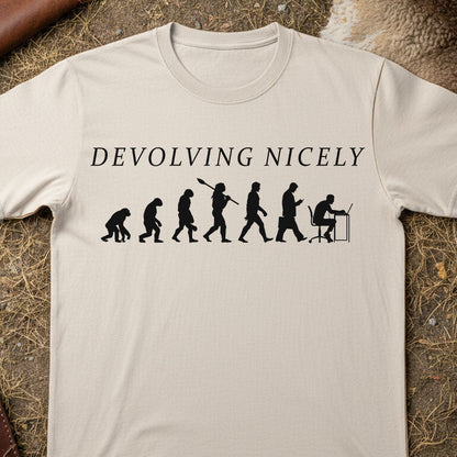 Beige t-shirt with 'DEVOLVING NICELY' text and evolution graphic on a textured surface.