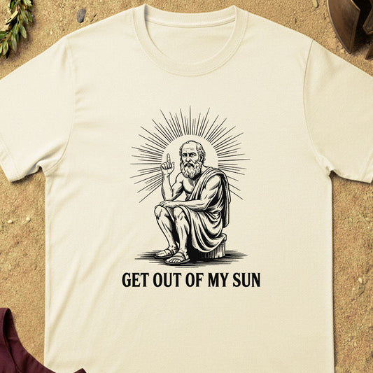 Beige t-shirt with a graphic of a seated figure and text 'GET OUT OF MY SUN' on a textured surface.