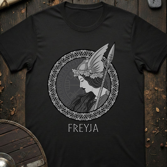 Black t-shirt with Freyja graphic design on a wooden background