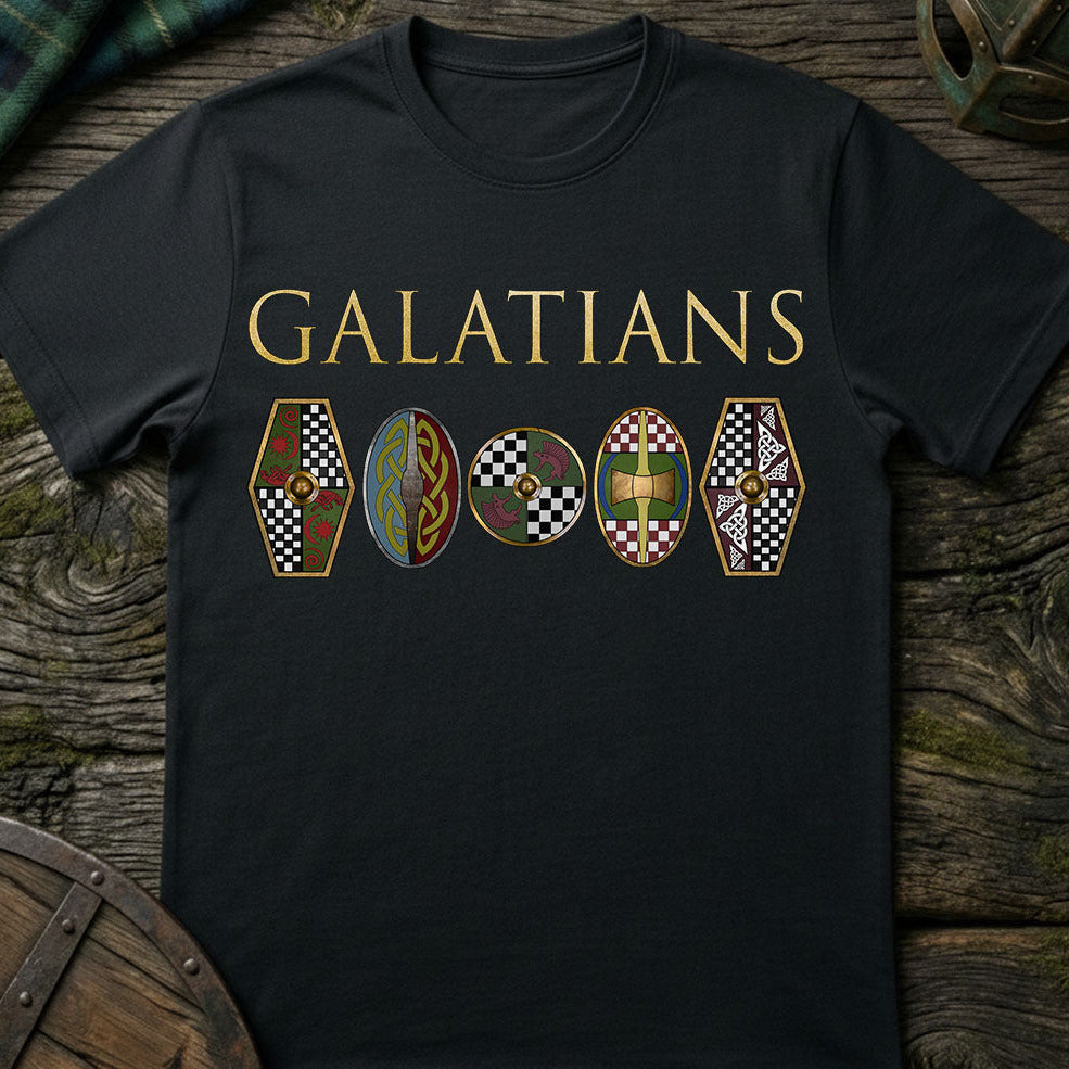 Black t-shirt with 'GALATIANS celtic tribe and shields' design on a wooden surface