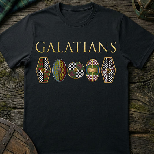 Black t-shirt with 'GALATIANS celtic tribe and shields' design on a wooden surface