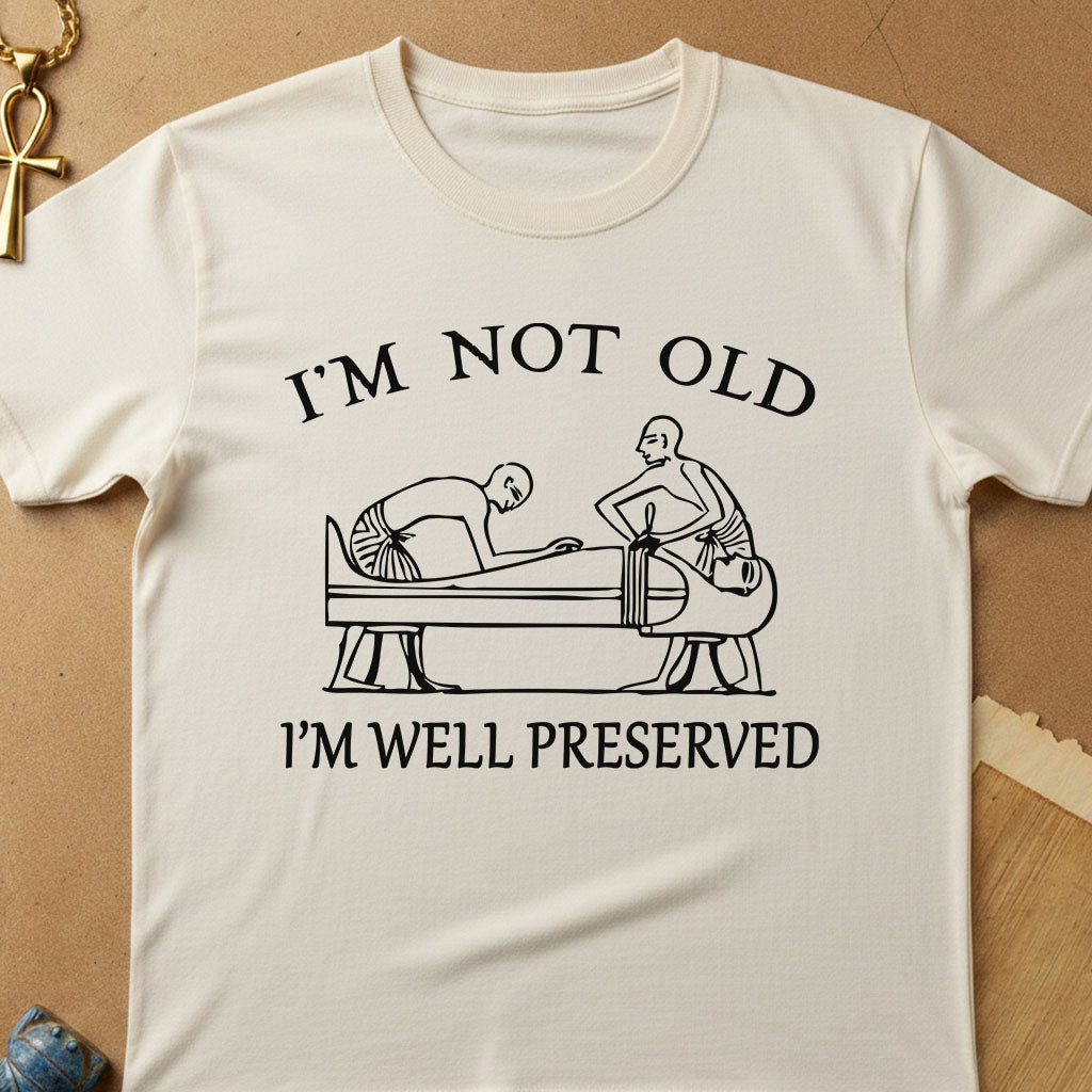 Natural t-shirt with humorous graphic and text on a beige background I'm Not Old I'm Well Preserved