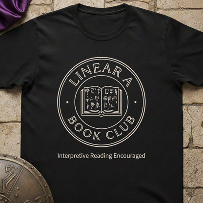 Black t-shirt with 'Linear A Book Club' design on a stone surface