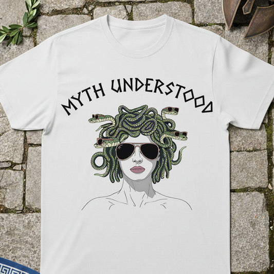White t-shirt with graphic design of Medusa and 'MYTH UNDERSTOOD' text on a stone surface.