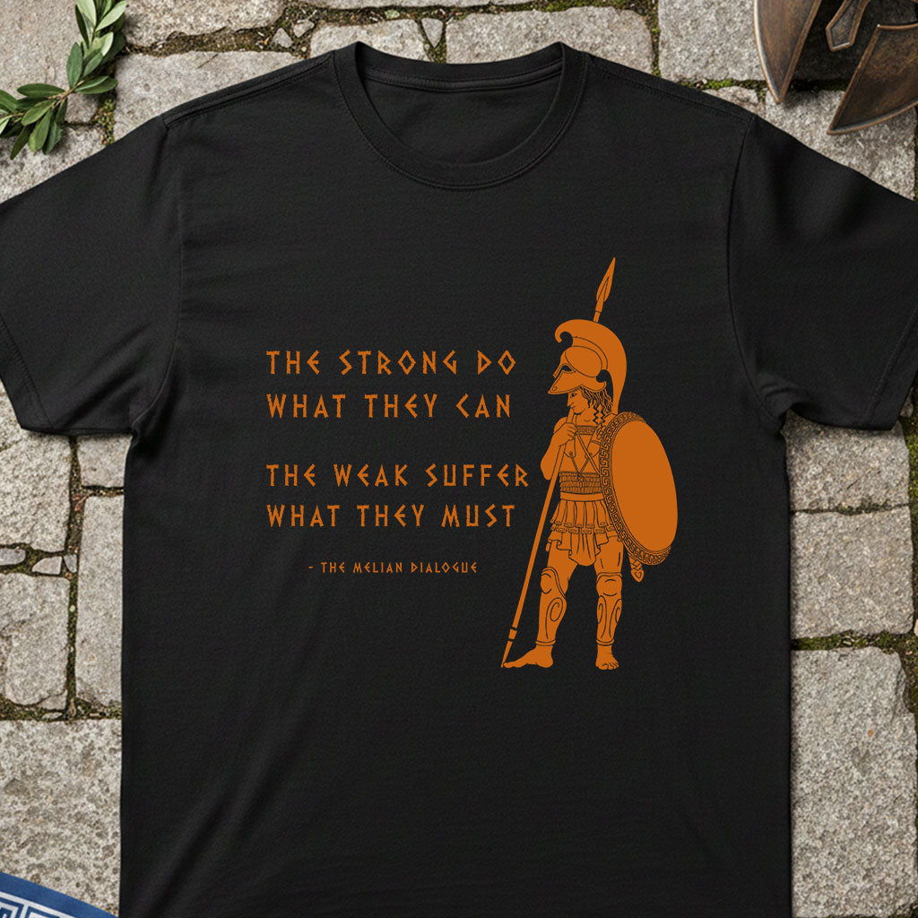 Black t-shirt with orange Spartan warrior graphic featuring the Melian Dialogue Quote and text on a stone surface