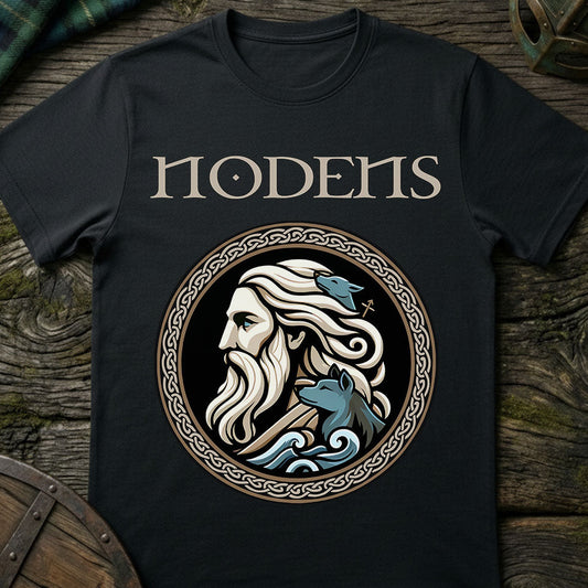 Black t-shirt with a graphic design of a bearded man and two wolves, featuring the word 'Nodens', on a wooden surface.