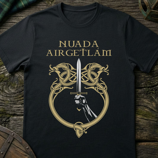 Black t-shirt with gold graphic and text on a wooden surface