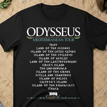 Black t-shirt with 'Odysseus Mediterranean Tour' text on a sandy background