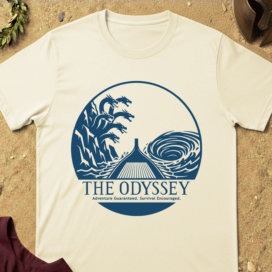 Beige t-shirt with 'The Odyssey' graphic design on a sandy background