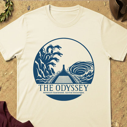 Beige t-shirt with 'The Odyssey' graphic design on a sandy background