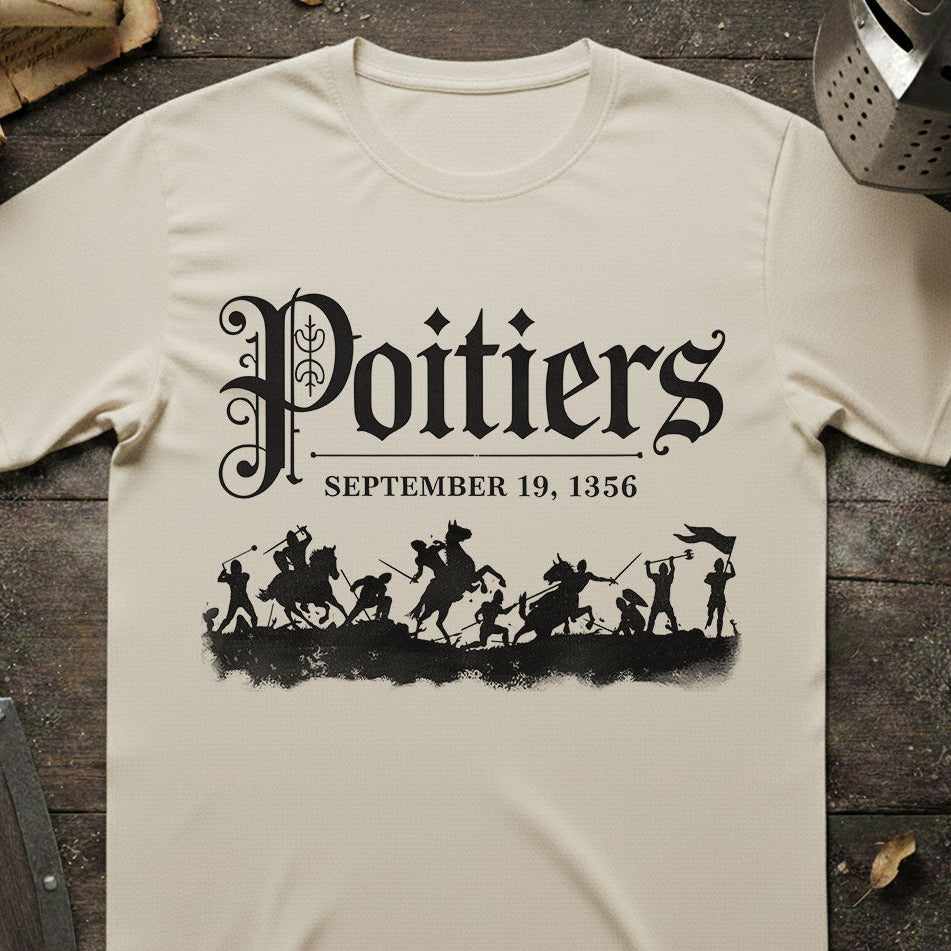 Beige t-shirt with black graphic and text 'Poitiers September 19, 1356' on a wooden surface.