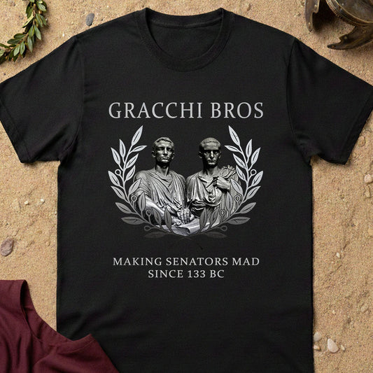 Black t-shirt with 'Gracchi Bros' design featuring statues and text on a textured surface.