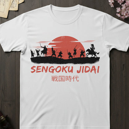 White t-shirt with 'Sengoku Jidai' design featuring silhouettes of samurai warriors and a red sun on a wooden surface.