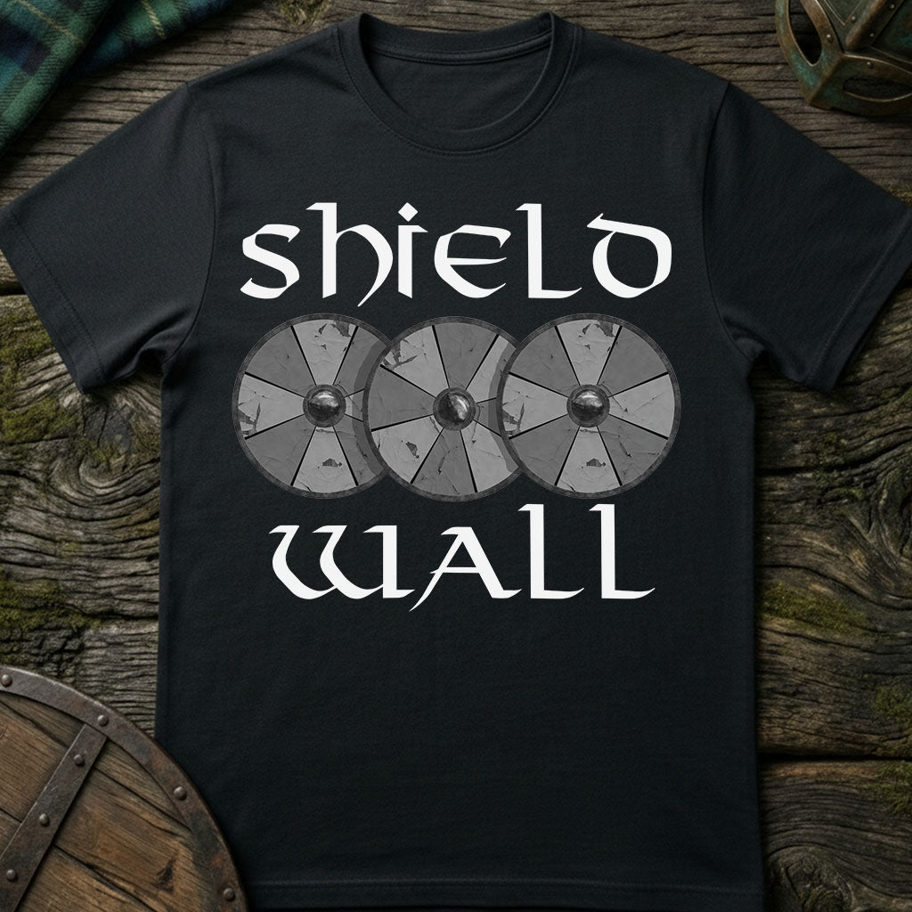 Black t-shirt with 'shield wall' design on a wooden surface