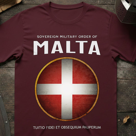 Maroon t-shirt with Sovereign Military Order of Malta logo on a wooden surface