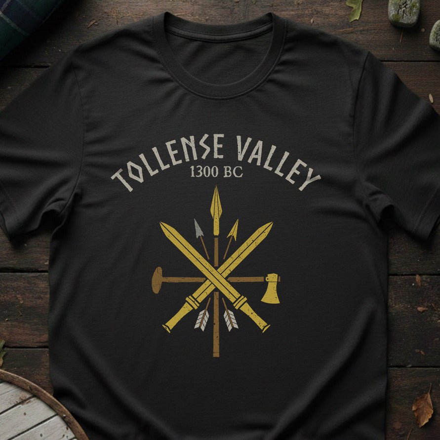 Black t-shirt with 'Tollense Valley 1300 BC' design on a wooden surface