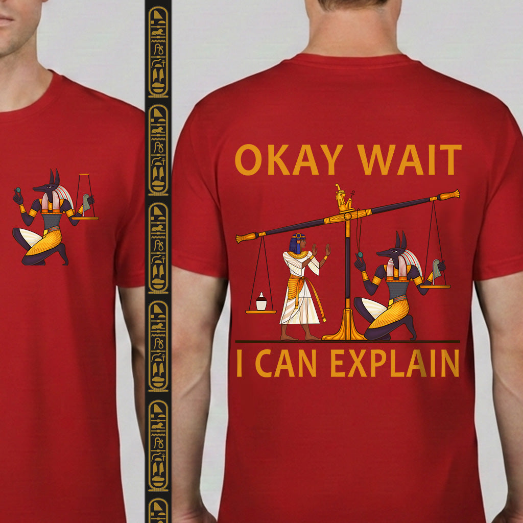 Red t-shirt with Egyptian-themed graphic and text 'OKAY WAIT I CAN EXPLAIN' on a plain background