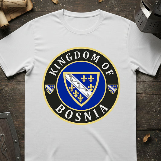 White t-shirt with 'Kingdom of Bosnia' emblem design on a wooden surface.