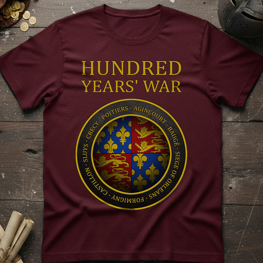 Maroon t-shirt with 'Hundred Years' War' design on a wooden surface.