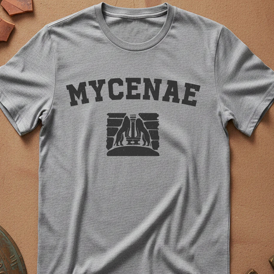 Gray t-shirt with 'MYCENAE' text and logo on a brown surface