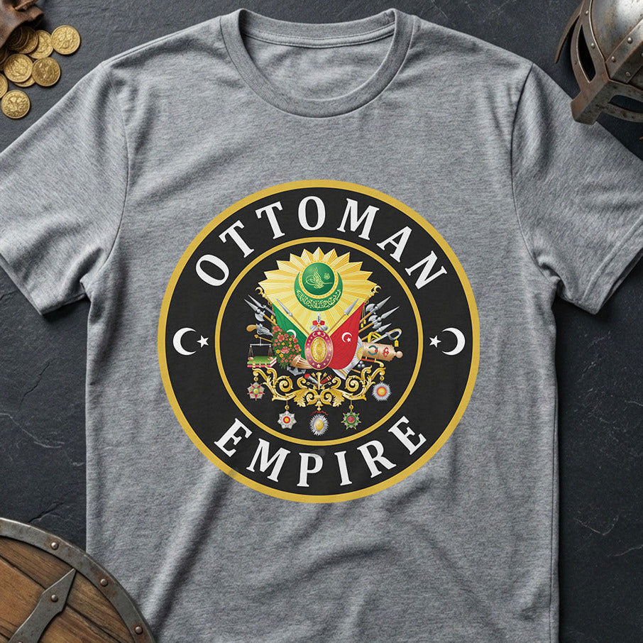 Gray t-shirt with Ottoman Empire logo on a dark surface with coins and a shield.