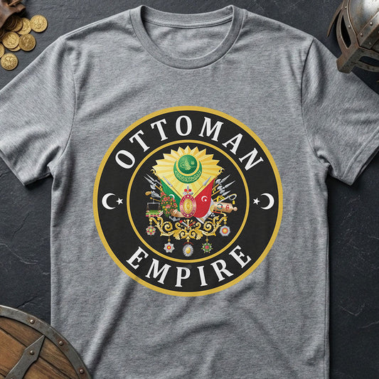 Gray t-shirt with Ottoman Empire logo on a dark surface with coins and a shield.