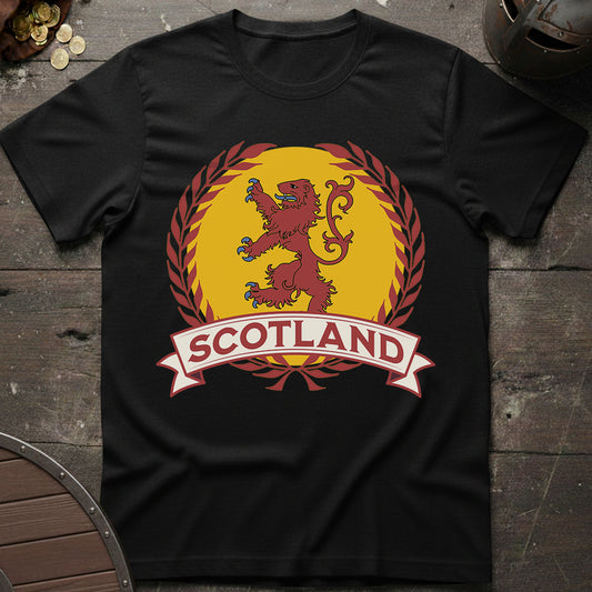 Black t-shirt with a red lion and 'Scotland' text on a wooden surface