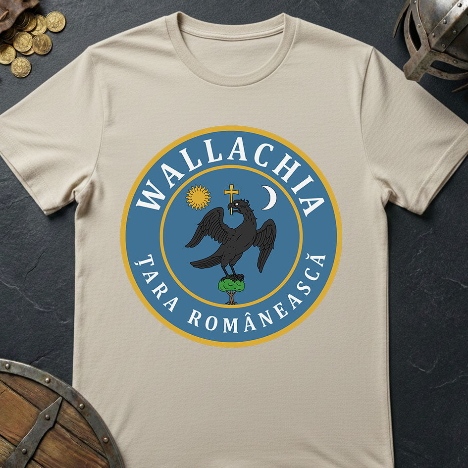 Beige t-shirt with Wallachia emblem on a dark surface with coins and a helmet.